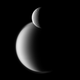 Rhea (front) and the much larger Titan (back).
